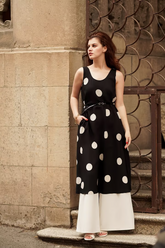 a lady wears a polka dots printed dress with white loose fit pants